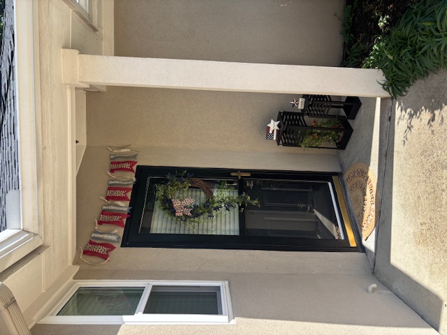Sophisticated black door with patriotic burlap banner, wreath, and decorative star-topped lanterns for elegant 4th of July styling